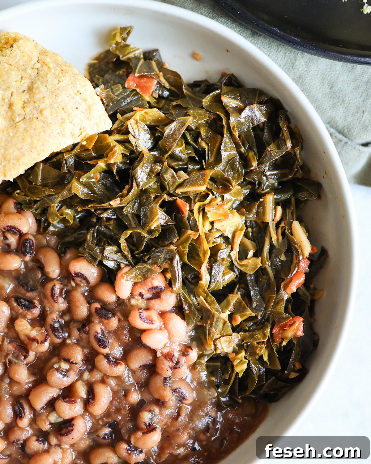 Cooked collard greens and black eyed peas in a bowl.