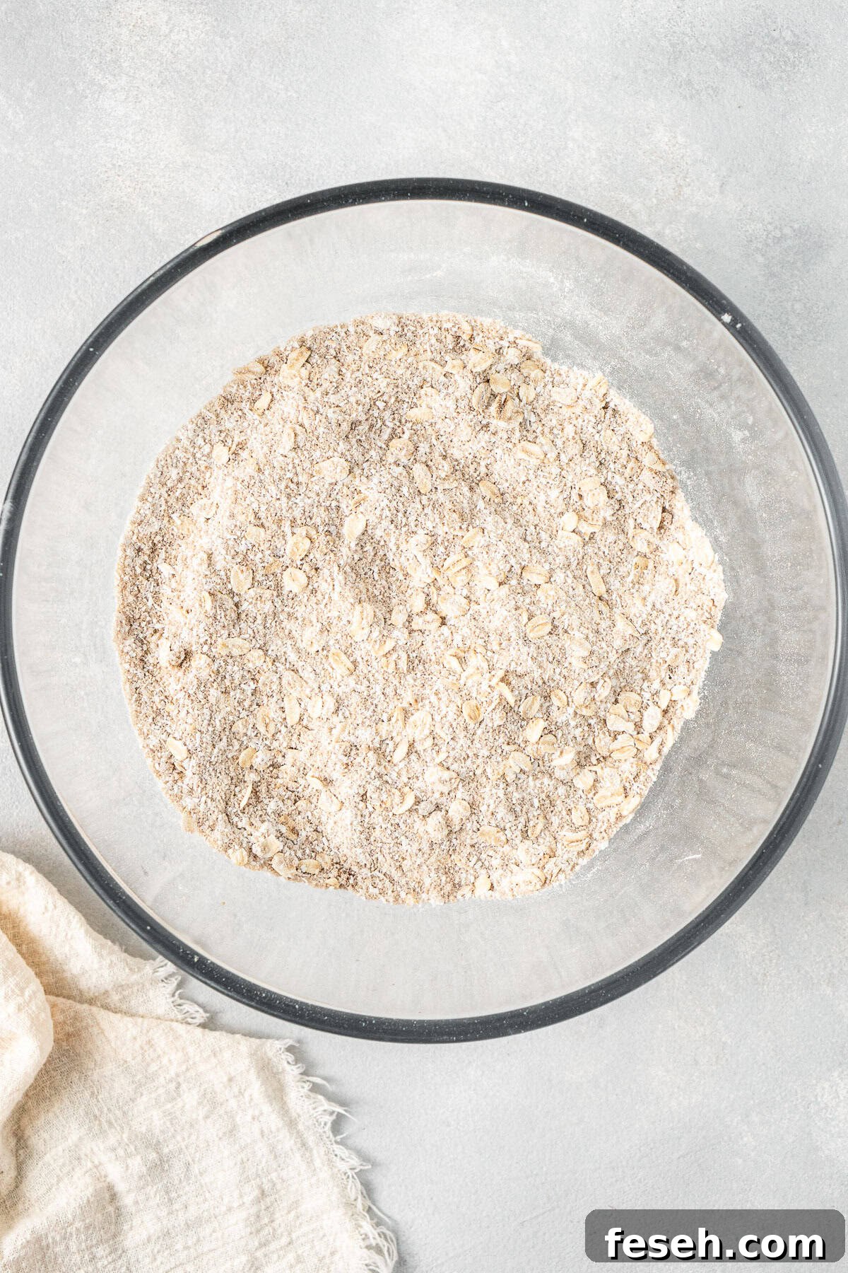 All dry ingredients mixed together in a glass bowl.