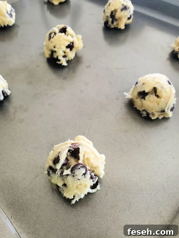 Chocolate Chip Cake Mix Cookie dough balls on a metal baking sheet