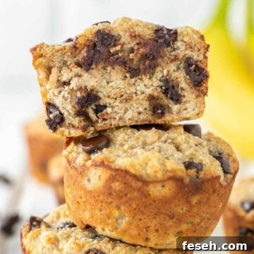 3 stacked almond flour banana muffins with one on top cut in half.