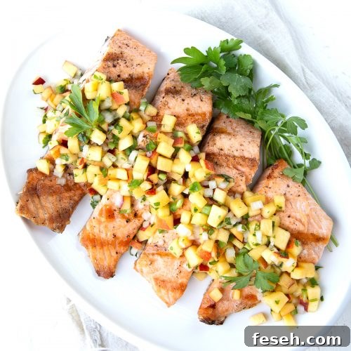 salmon with nectarine salsa on a white platter