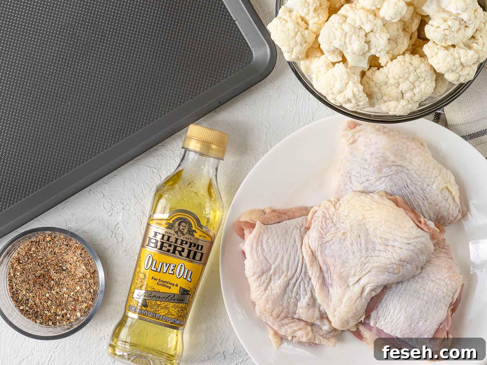 Ingredients. Bone in, skin on, chicken thighs, extra virgin olive oil, cajun seasoning blend, and cauliflower.