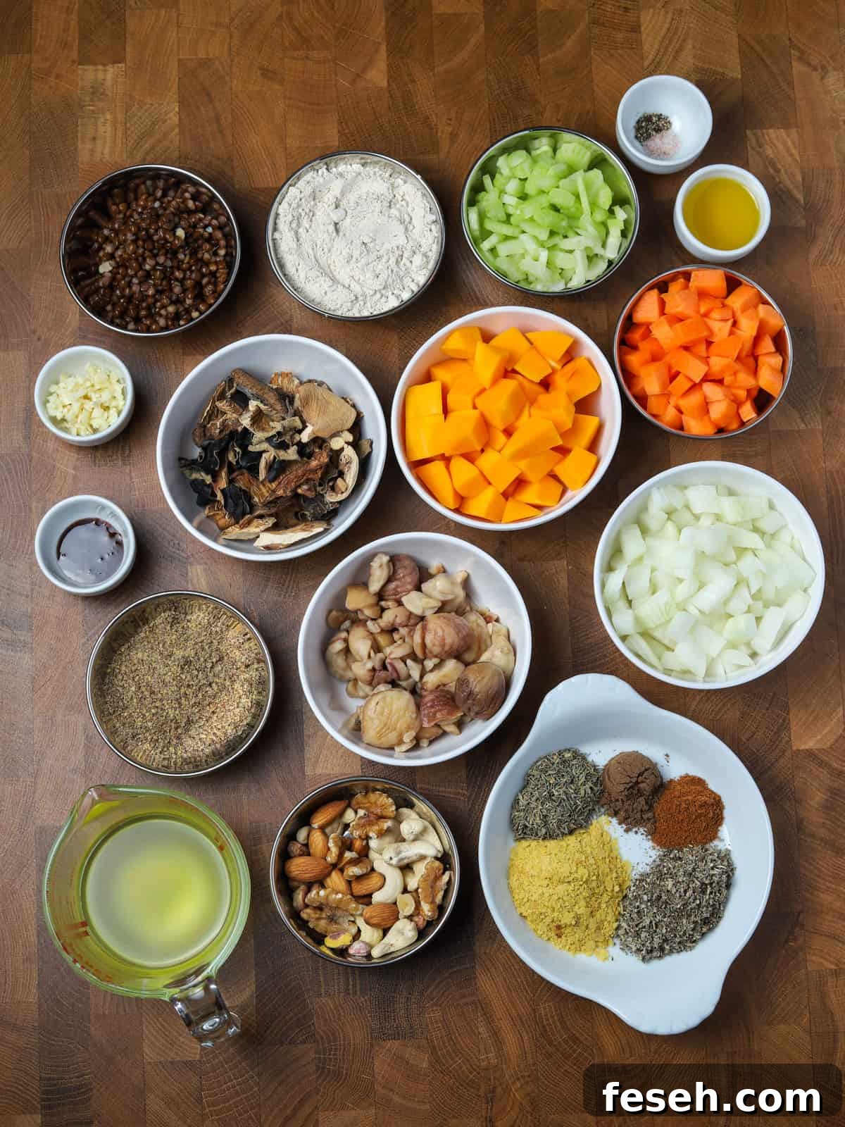 Photo of all the ingredients for making this vegan and gluten-free nut roast recipe, all laid in bowls on a wooden countertop.