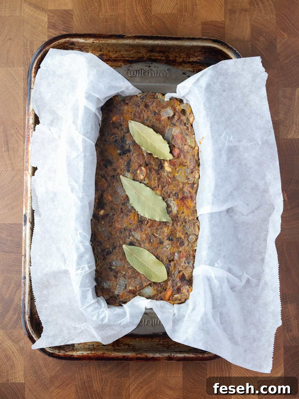 Photo of vegan nut roast in the lined loaf tin ready to go in the oven.