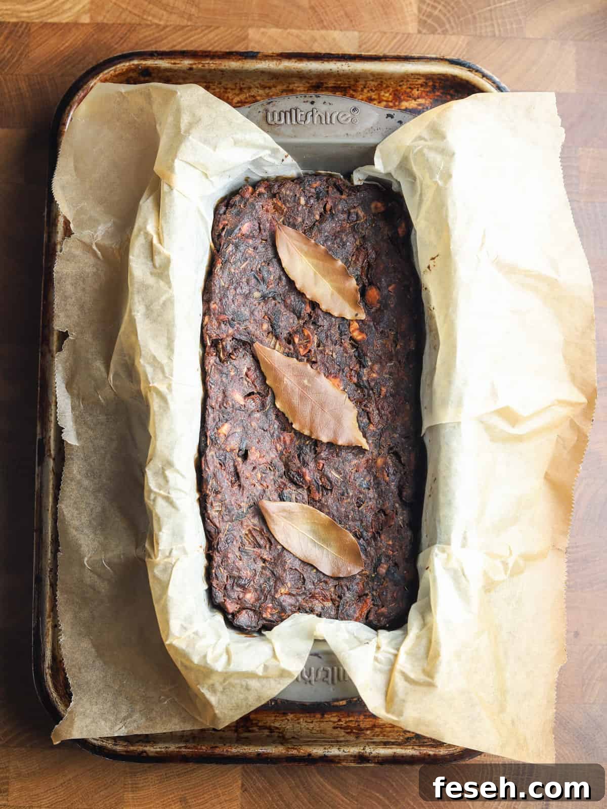 Photo of vegan & gluten-free nut roast in the loaf tin after roasting.