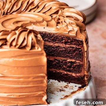 Triple chocolate cake sliced on a platter.