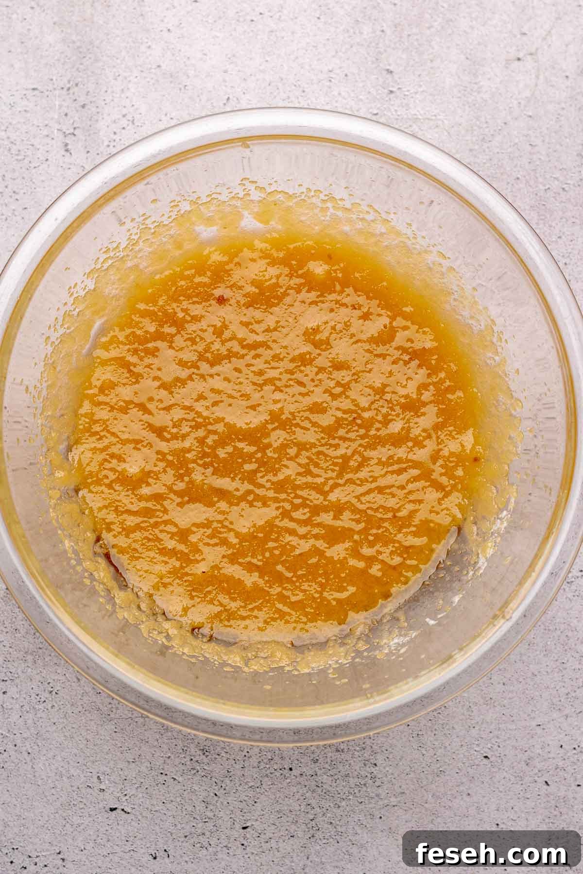 Butter, oil, and sugars mixed together in bowl.