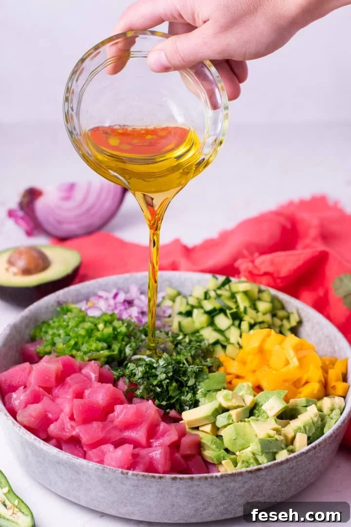 hand pouring olive oil into the mixture