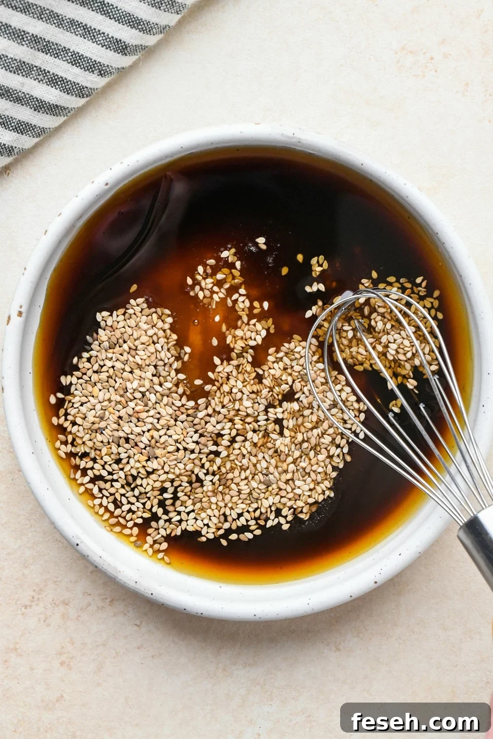 How to make cucumber sesame salad: Dressing ingredients in a small bowl before whisking together.