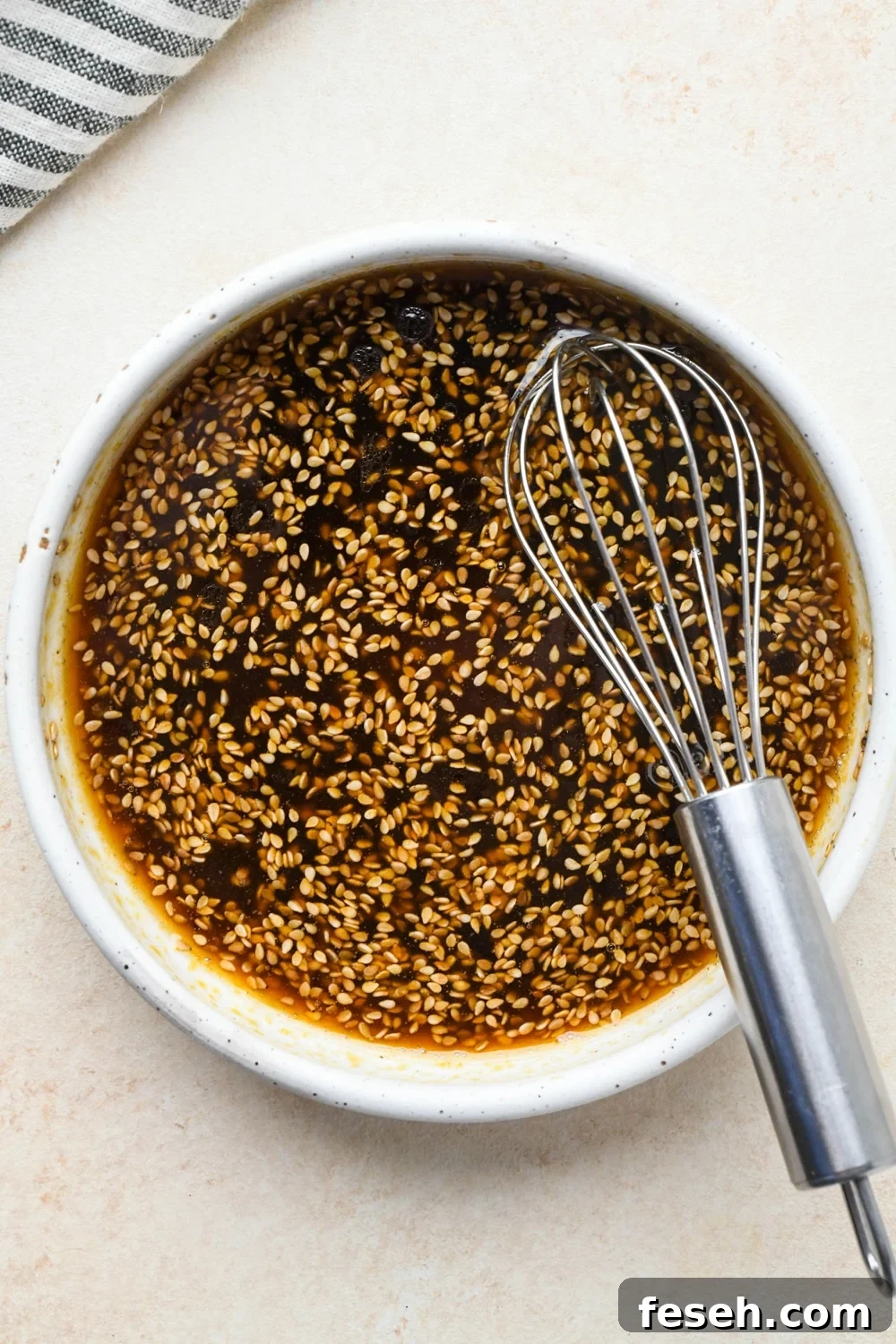How to make cucumber sesame salad: Dressing ingredients in a small bowl after whisking together.