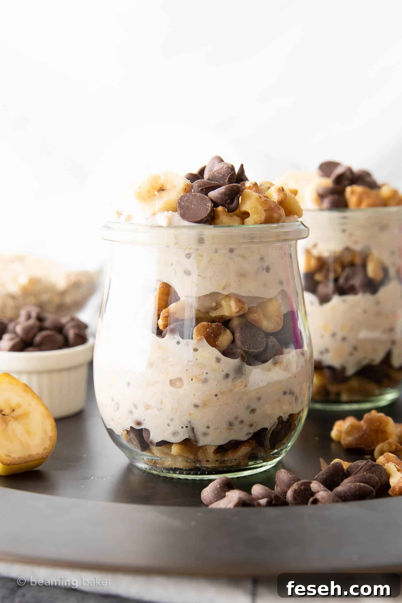 closeup head-on tall glass jar filled with chunky monkey overnight oats