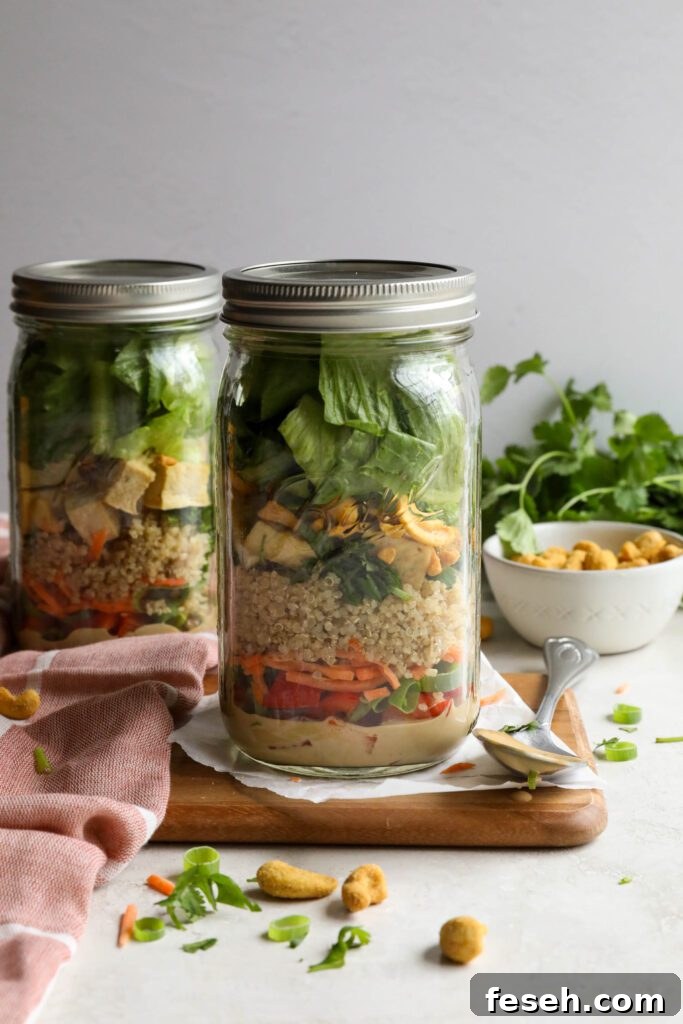 Thai Mason Jar Salads on board with cashews and cilantro in background 