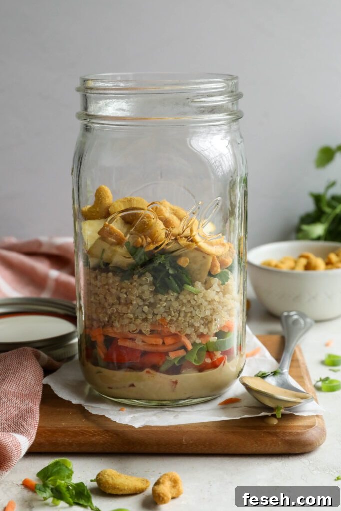 Thai Mason Jar Salads on board with cashews and cilantro in background 