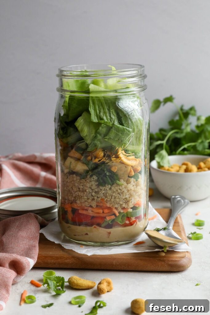 Thai Mason Jar Salads on board with cashews and cilantro in background 