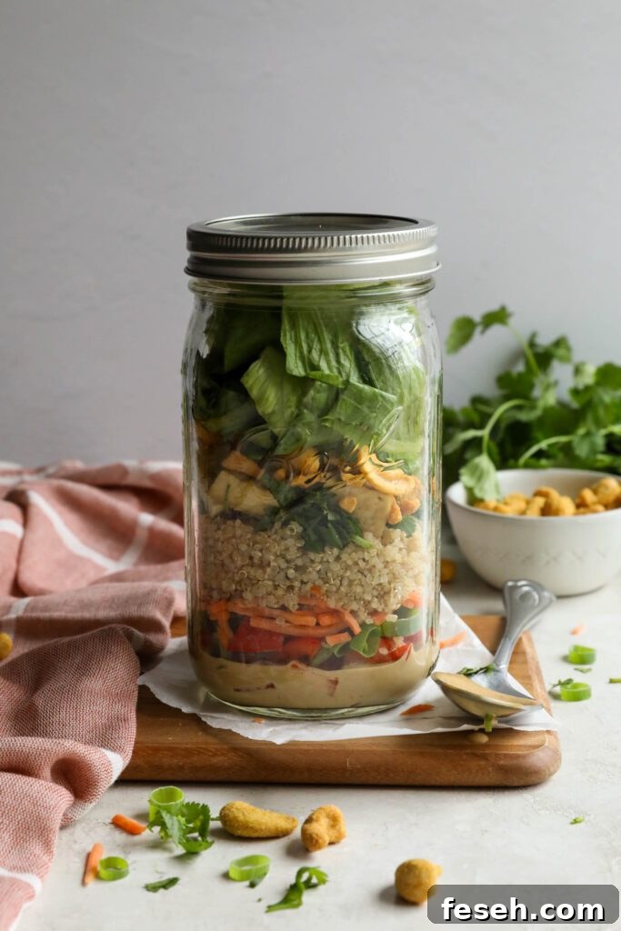 Thai Mason Jar Salads on board with cashews and cilantro in background 
