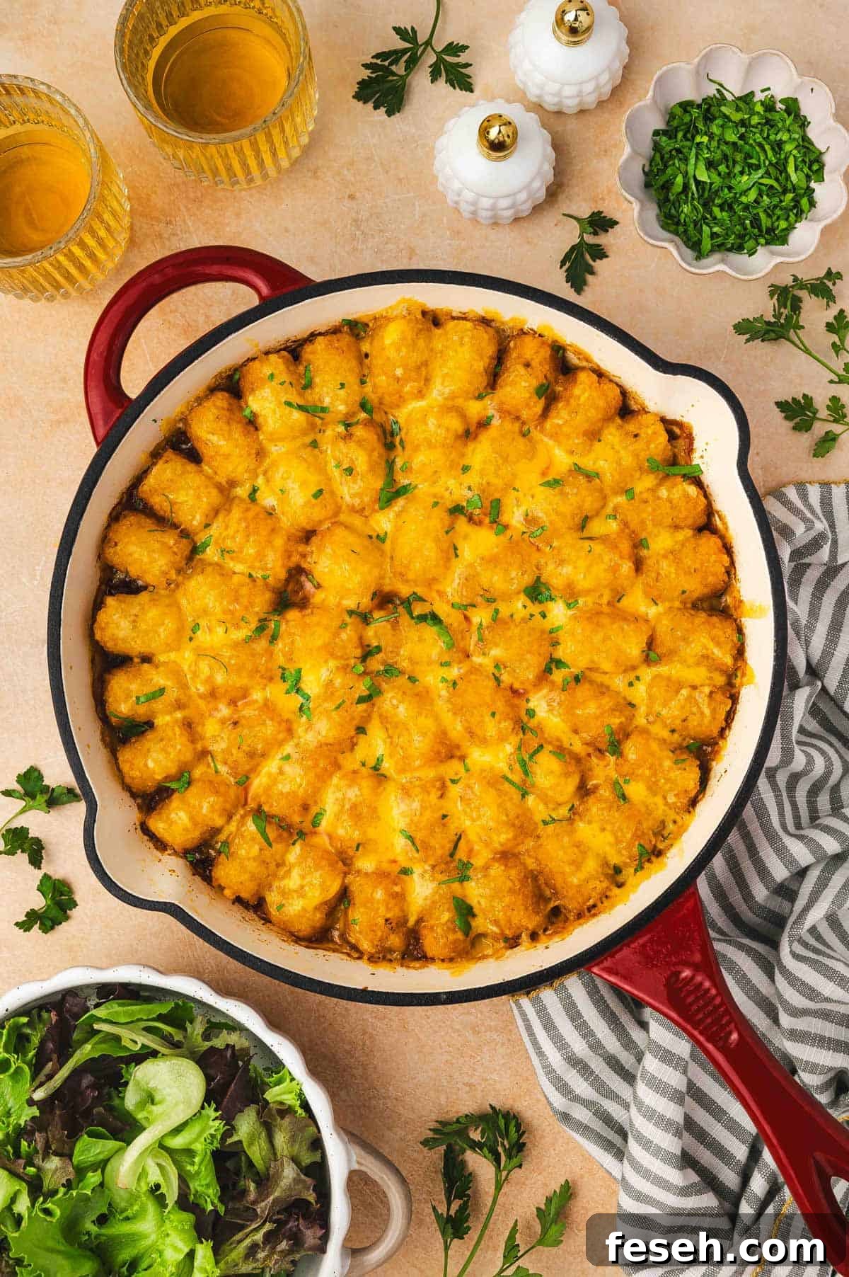 Overhead view of sloppy joe tater tot casserole in a large skillet.