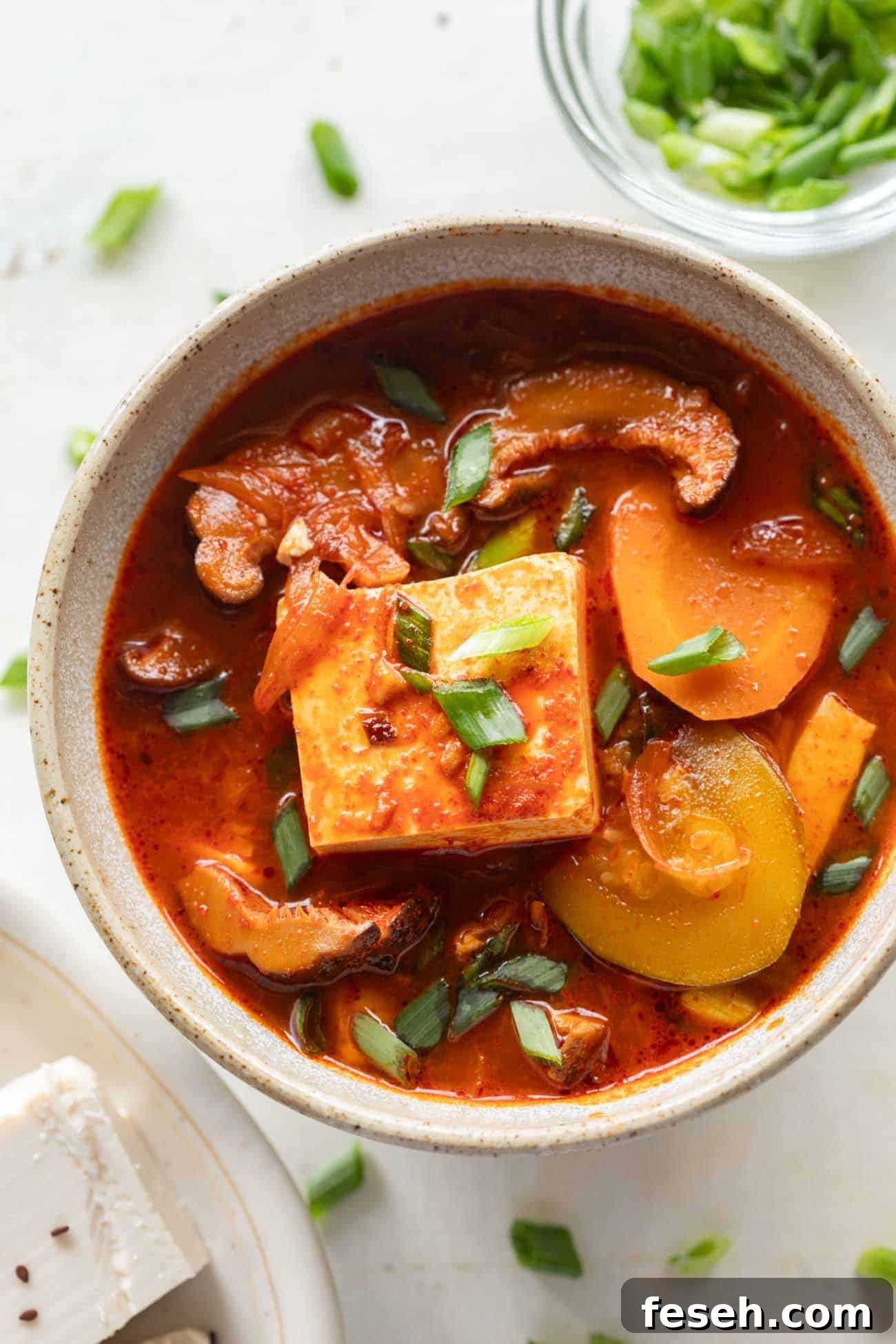 Soondubu Jjigae: Spicy Korean Soft Tofu Stew Recipe 2 korean soft tofu stew in a white bowl