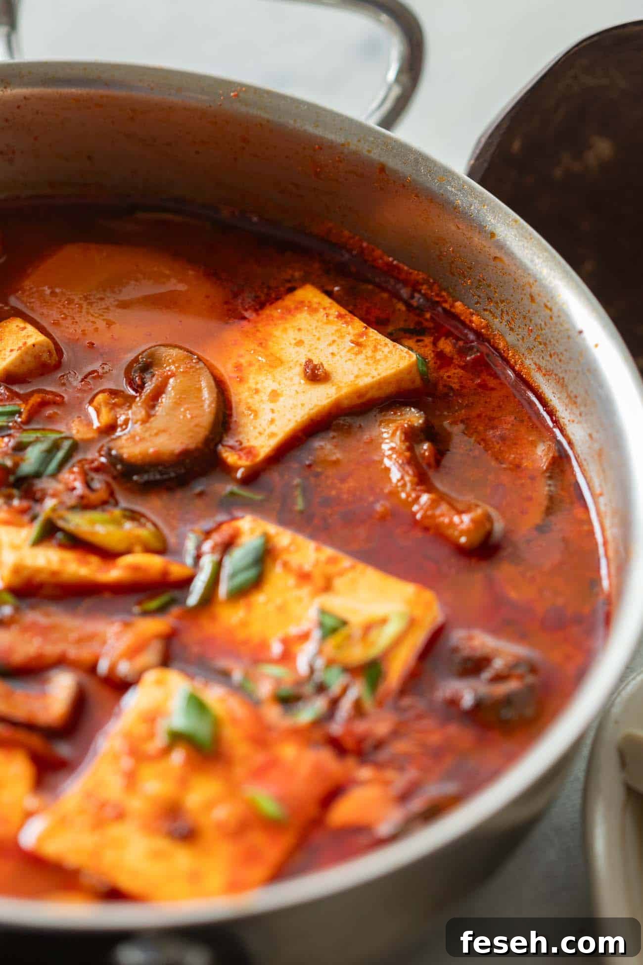 Soondubu Jjigae: Spicy Korean Soft Tofu Stew Recipe 6 korean soft tofu stew in a white bowl
