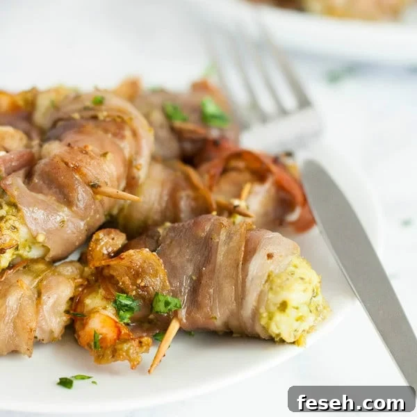 Shrimp with pesto and prosciutto on a plate.