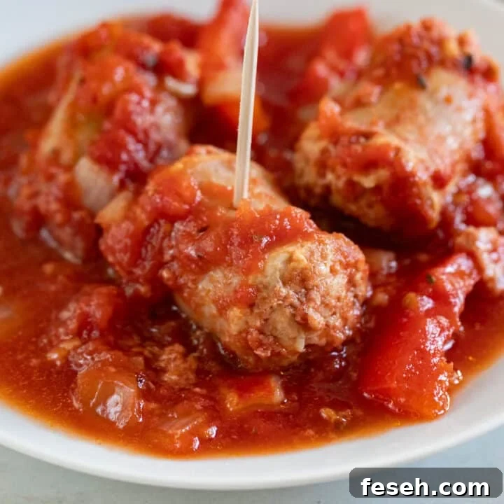 A close up image of Italian sausage in tomato sauce.