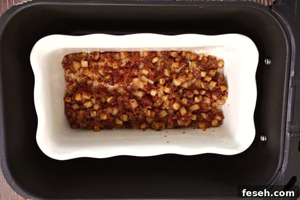 corned beef hash being cooked in a dish safe for the air fryer