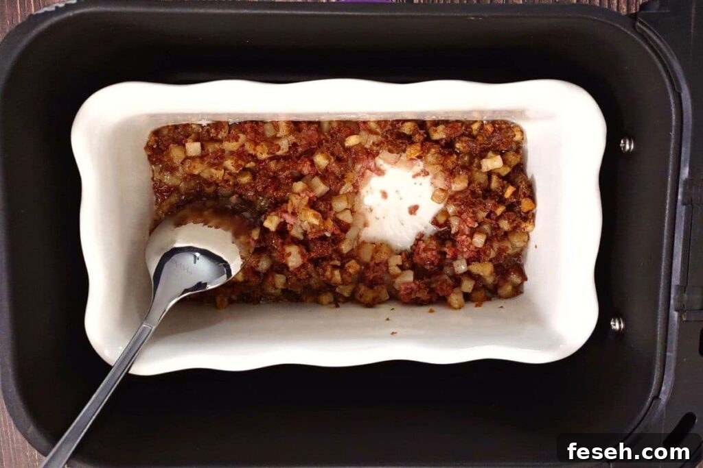use a spoon to dig two wells in the corned beef hash