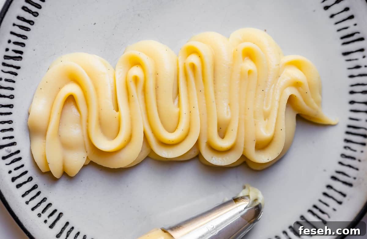 close up of piped pastry cream on a plate showing it does not fall or lose shape.