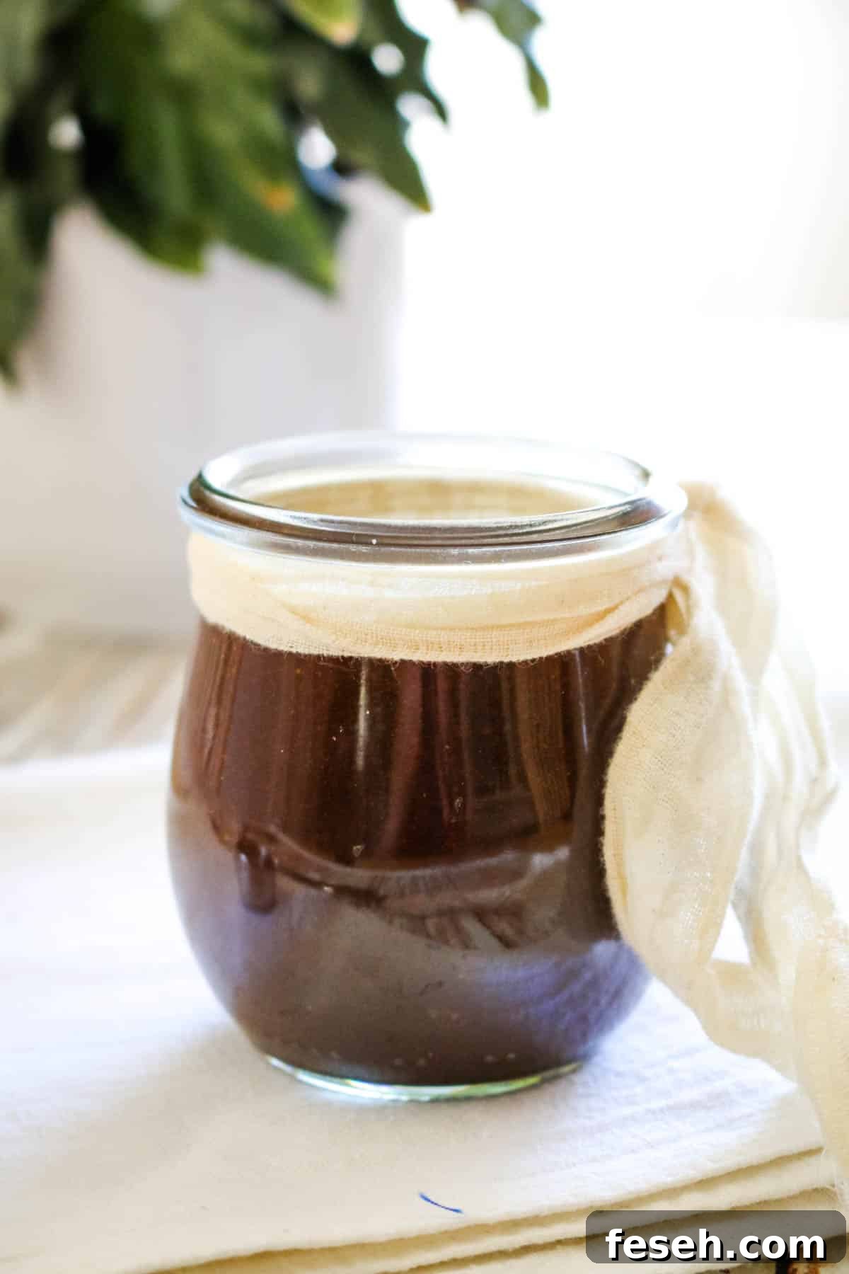 dark sauce in small jar with white ribbon