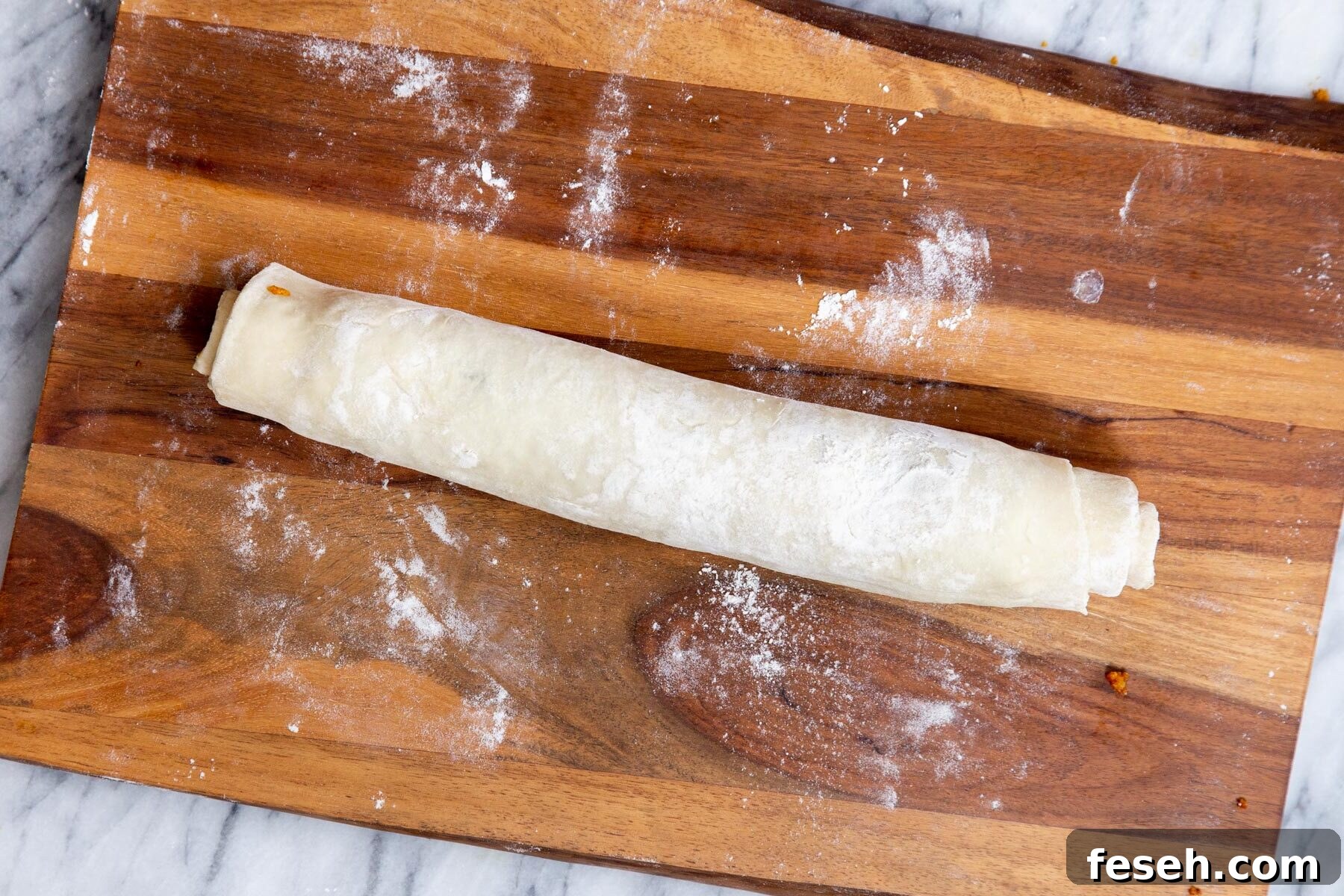 rolled up filled puff pastry ready for cutting into pinwheels 