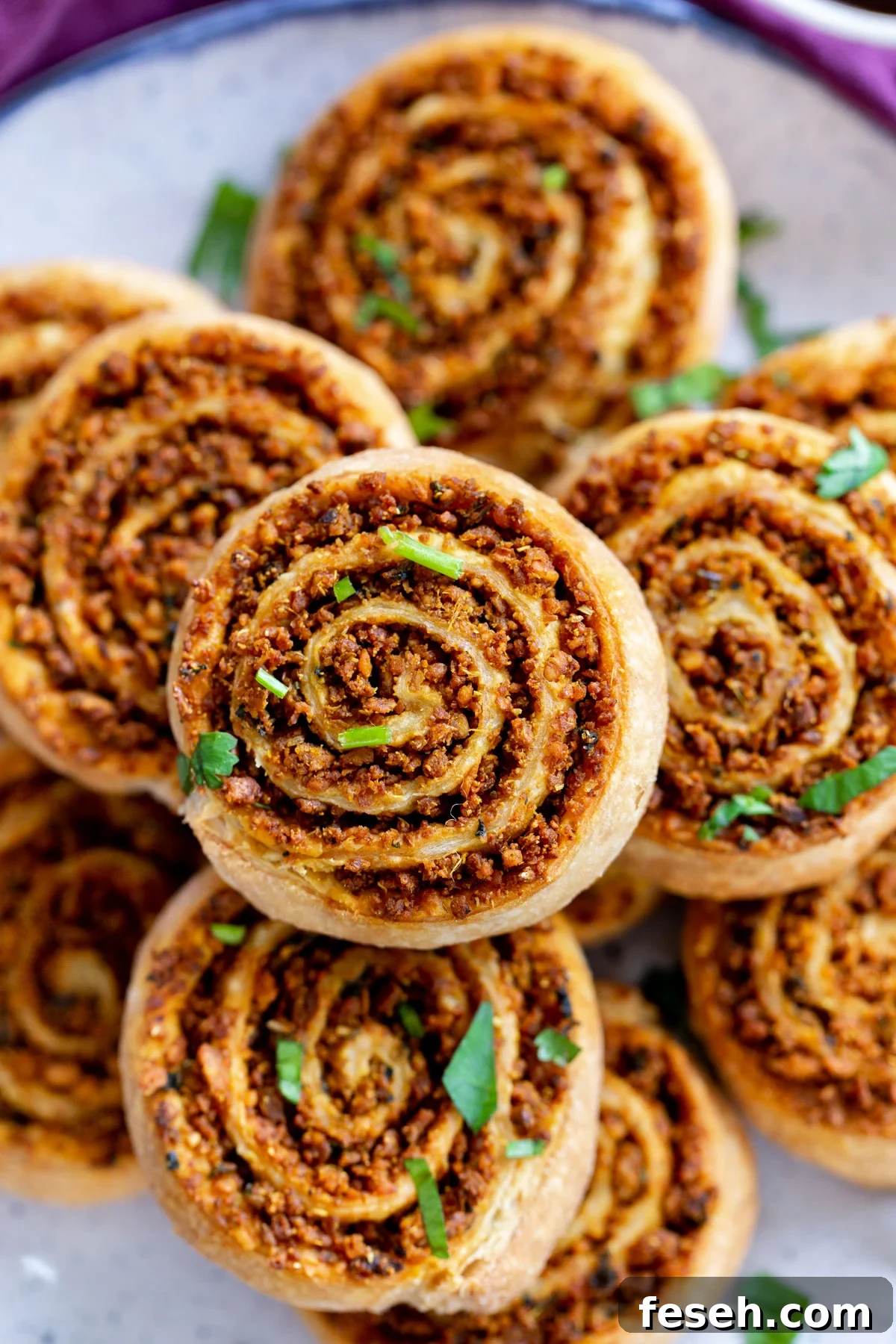 close up of a platter of puff pastry pinwheels with lentil filling 