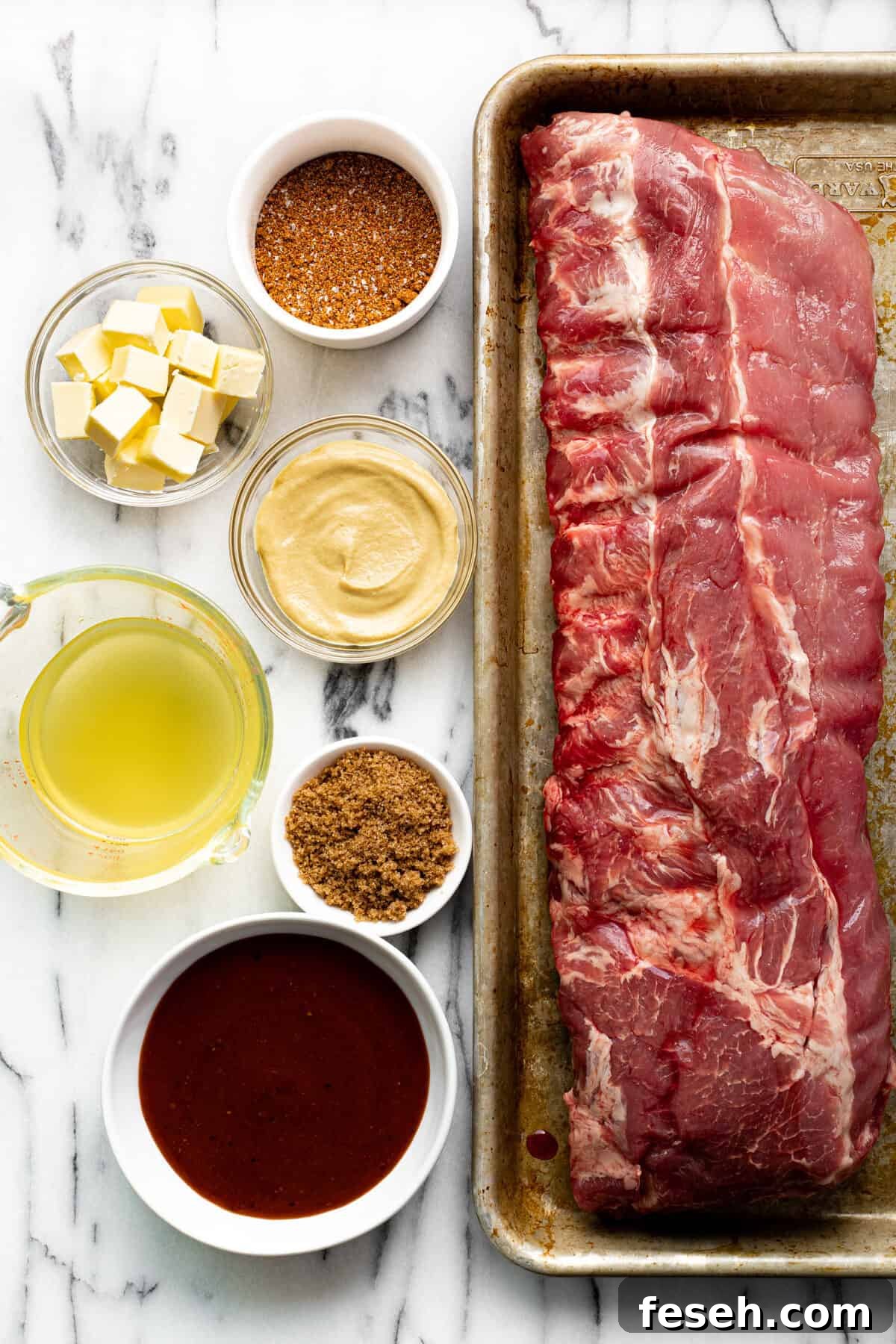 White marble countertop with bowls of ingredients to make ribs.