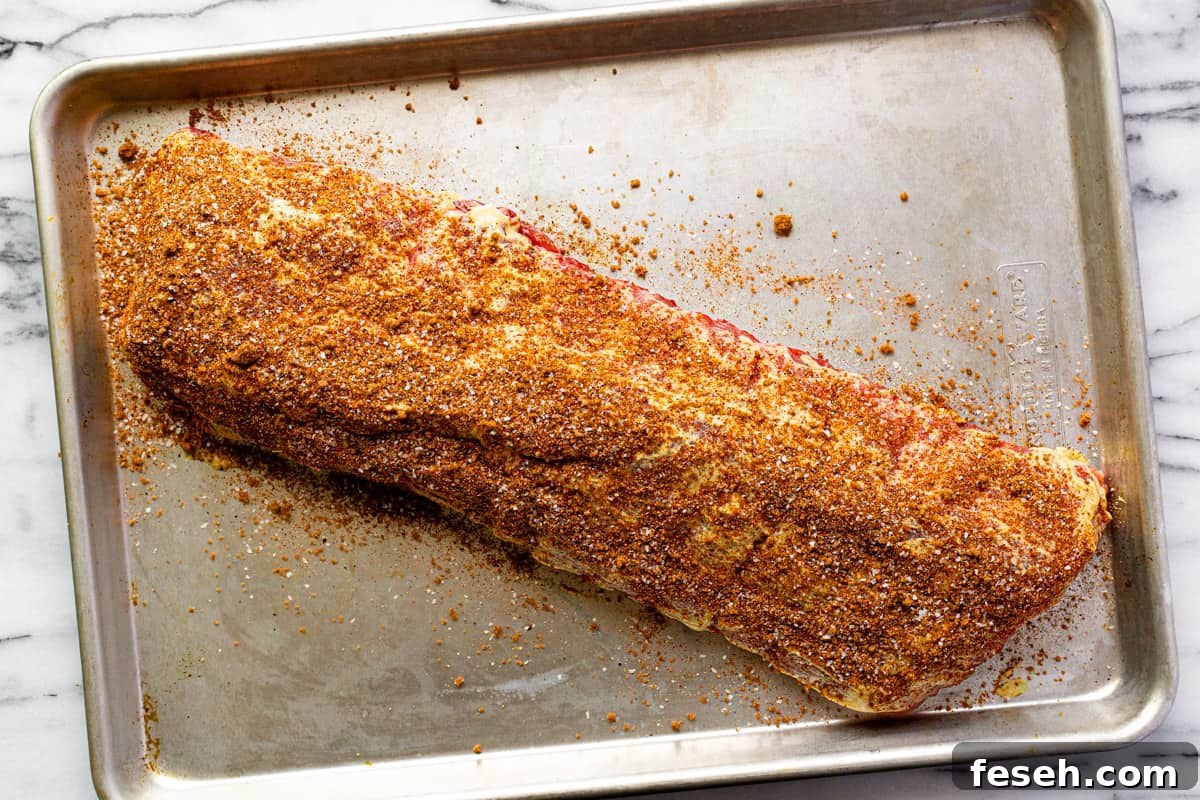 Sheet pan with seasoned baby back ribs.