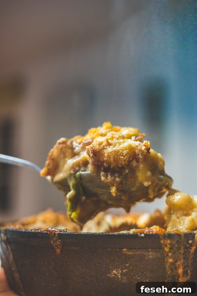 Cauliflower Cheese & Gnocchi Bake Coming being spooned from dish - Georgie Eats