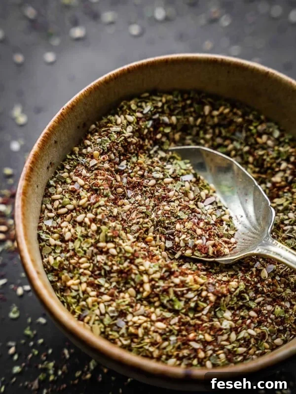 Za'atar spice blend in a bowl with an antique spoon.