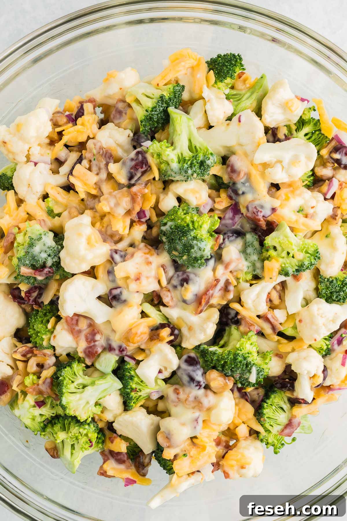 salad with broccoli and cauliflower in a bowl with cheese and bacon