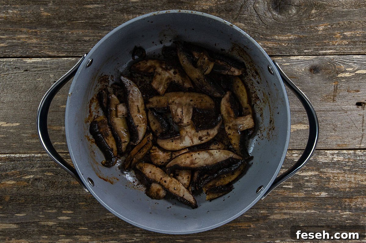 Sliced portobella mushrooms in the Dutch oven.