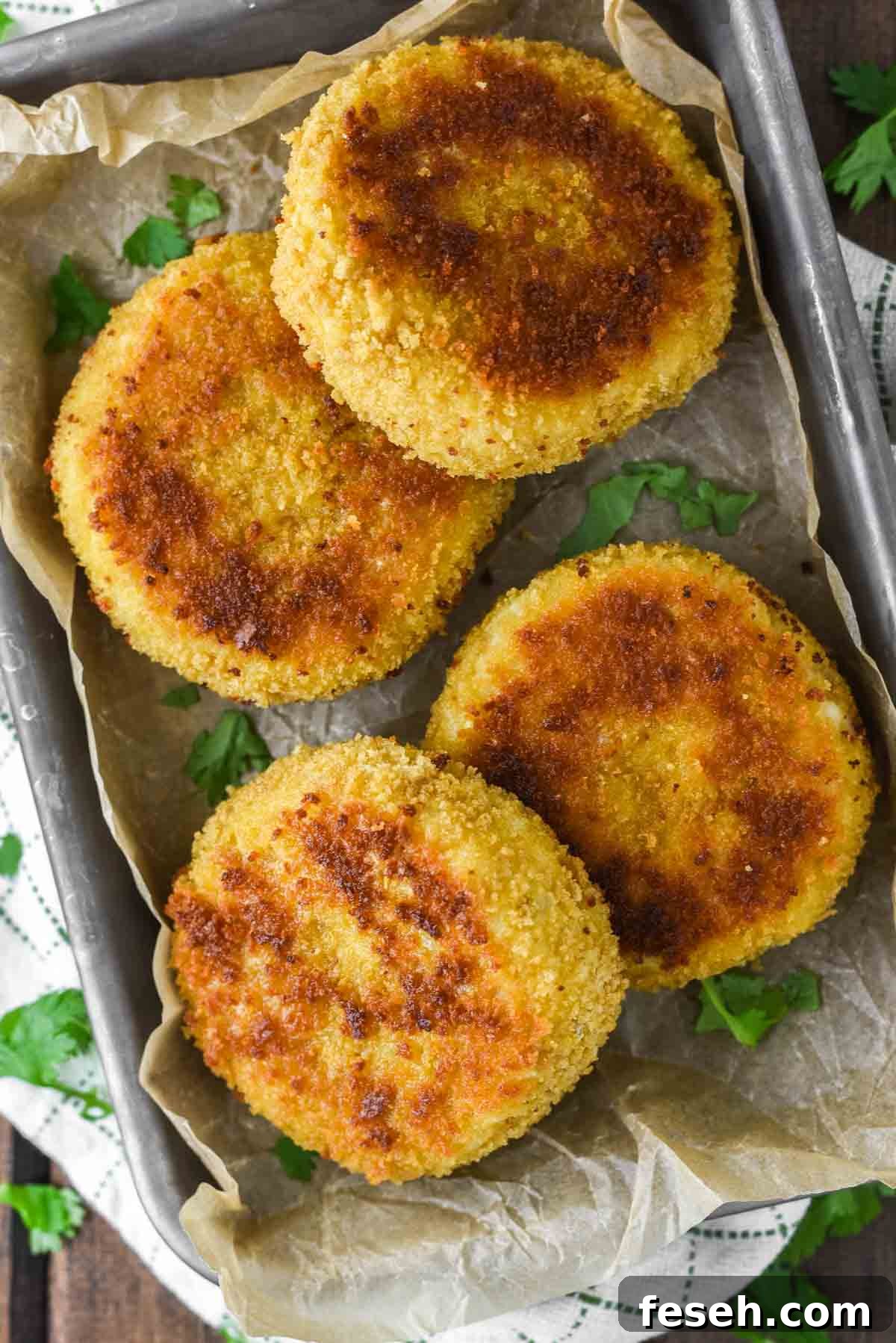 overhead shot of risotto cakes in parchment-lined tin