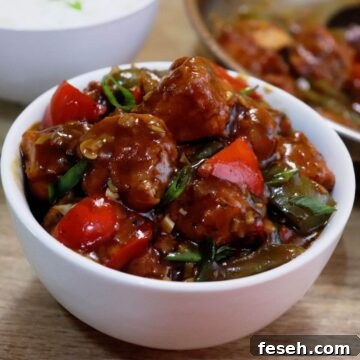 chilli chicken gravy served in a white bowl.