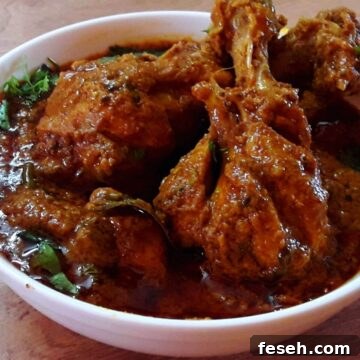 hyderabadi chicken masala served in a white bowl.