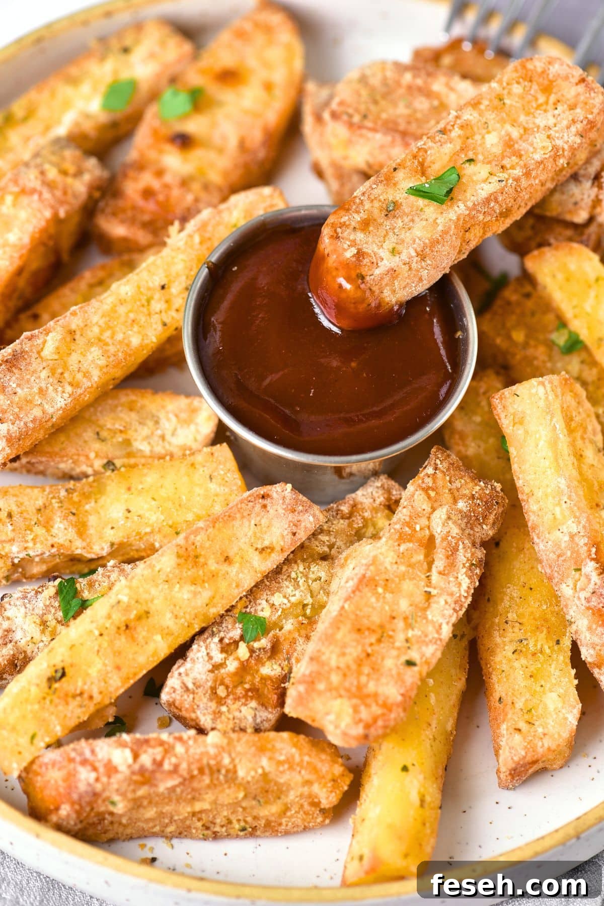 Dipping halloumi fries into ketchup