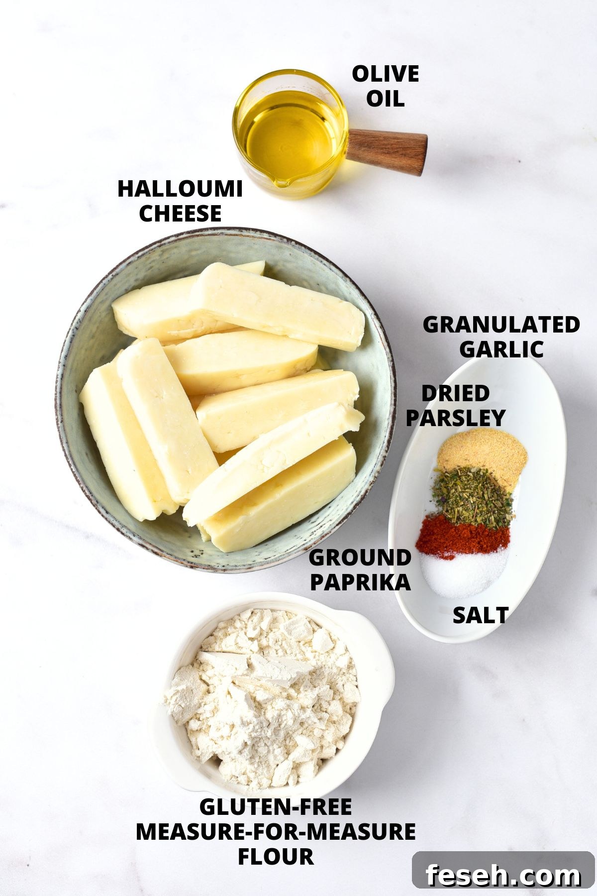 Ingredients for air fryer halloumi fries recipe laid out on marble board.