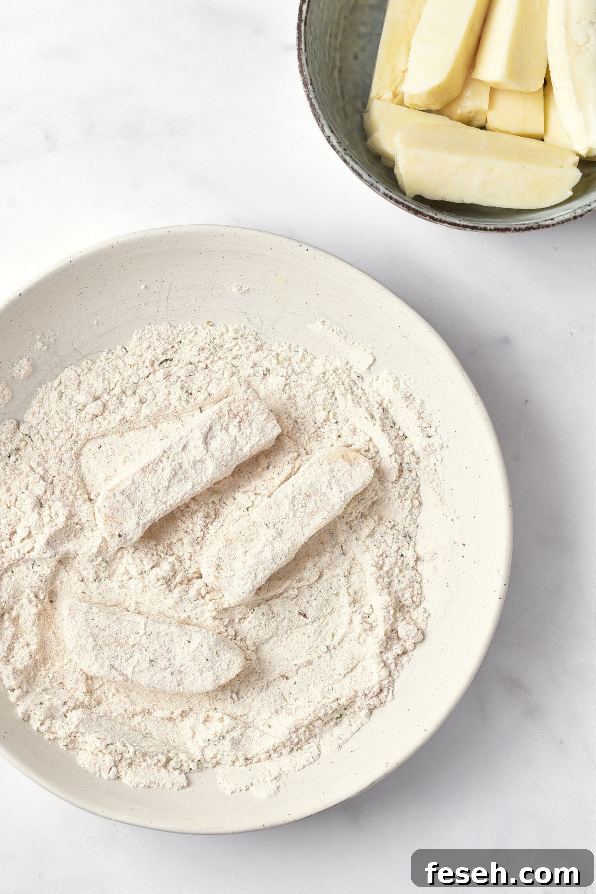 Coating halloumi cheese strips in flour mixture