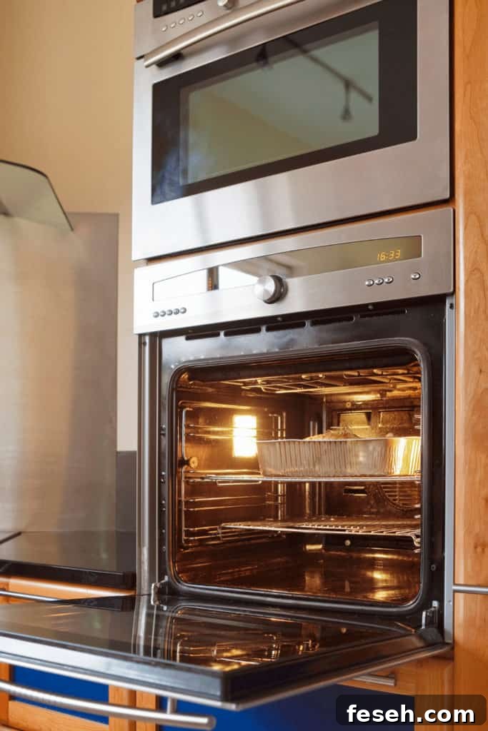 It is unsafe to cook in an oven that moldy food was in without cleaning