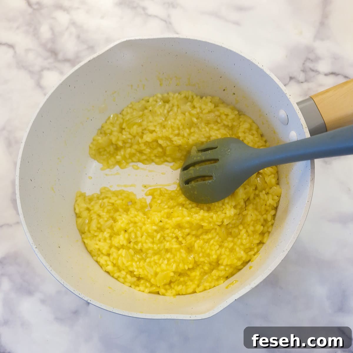 Cooked risotto in a saucepan showing the creamy consistency.