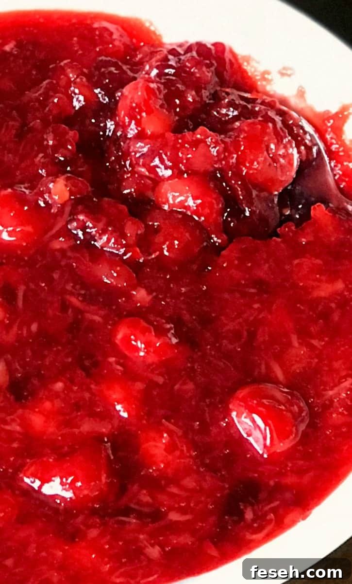 Cherry Coke Jello Salad Recipe — Retro Fizzy Dessert 10 Spoon in white bowl of Cherry Coke Jello Salad