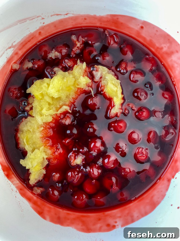 Cherry Coke Jello Salad Recipe — Retro Fizzy Dessert 6 Crushed pineapple poured into mixing bowl with heated jello, pie filling and cherry coke.