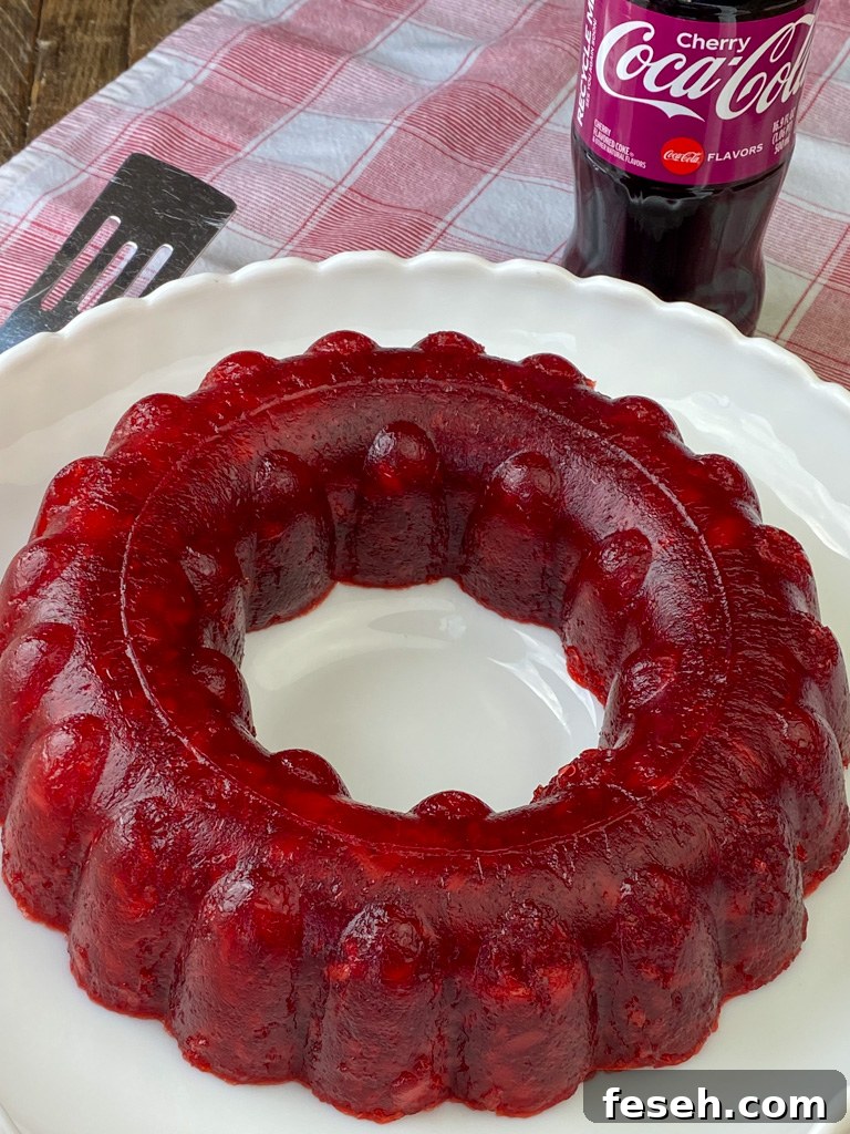 Cherry Coke Jello Salad Recipe — Retro Fizzy Dessert 8 Close up ring of jello salad filled with crushed pineapple, cherry pie filling with the cherry jello mixed with cherry coke.