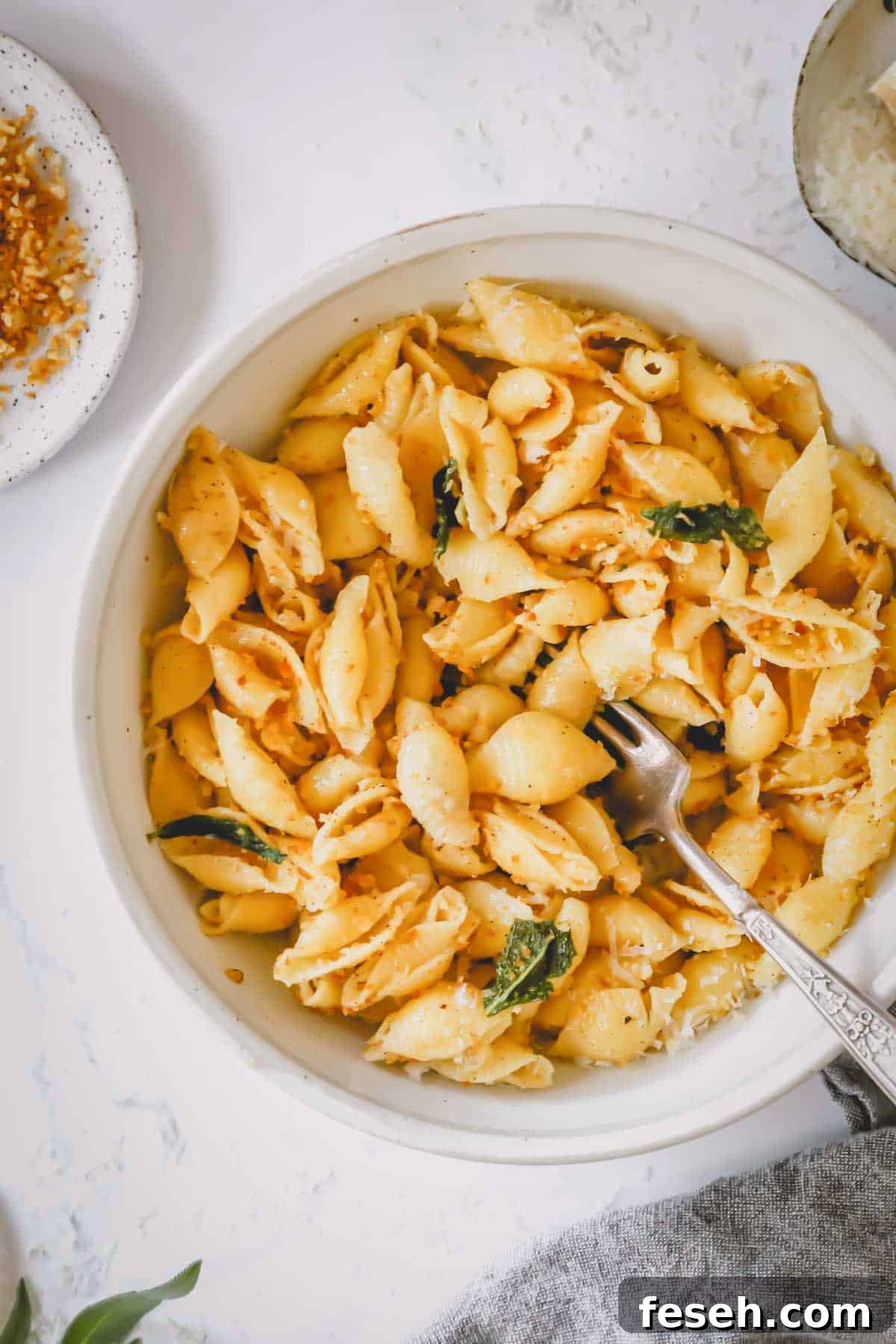 A bowl of brown butter pasta with a fork sticking out.