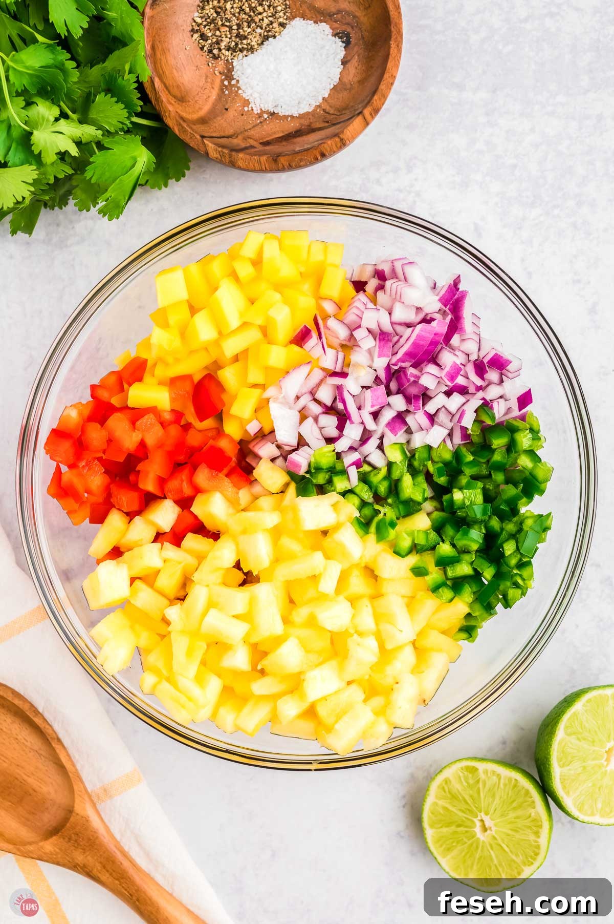 pineapple and other diced fruit in a clear bowl