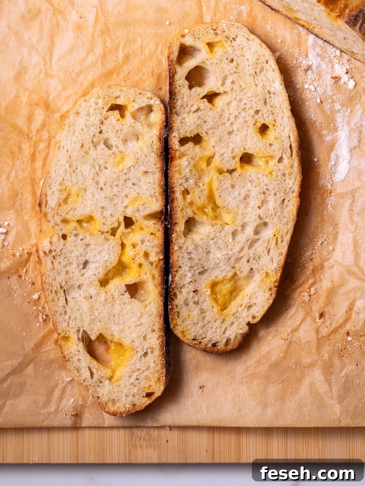 Slices of sourdough cheese bread with gooey pockets of melted cheese